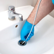 a man snaking a drain