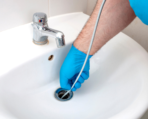 a man snaking a drain