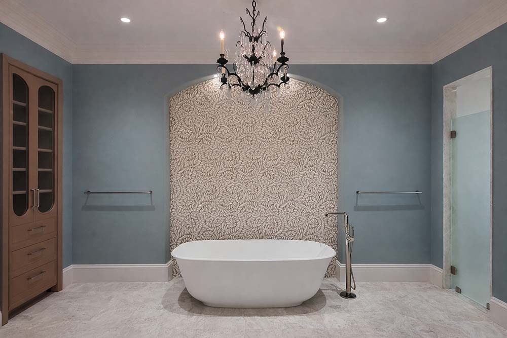 Modern bathroom remodel featuring freestanding soaking tub and floor-mounted faucet.