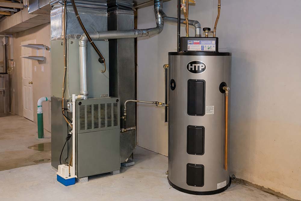 New high-efficiency HTP water heater installed in basement next to furnace with updated copper piping connections.
