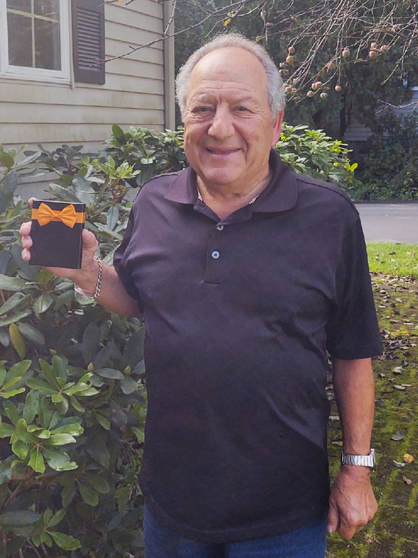 September 2021 Chase Plumbing sign contest winner holding a prize outdoors.